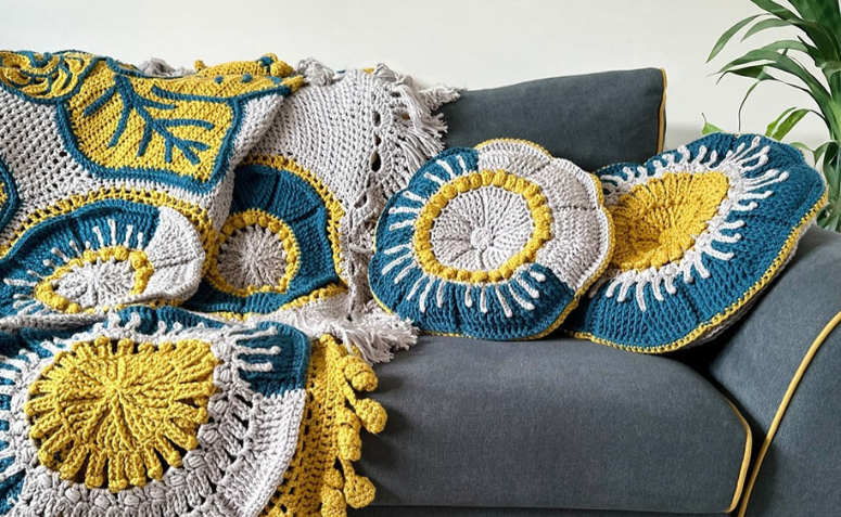 sofá com manta de crochê e capa para almofadas como atividades manuais para decorar a casa